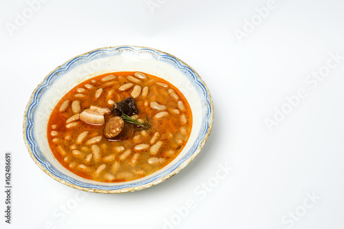 Stew of beans with chorizo and pork.Isolated