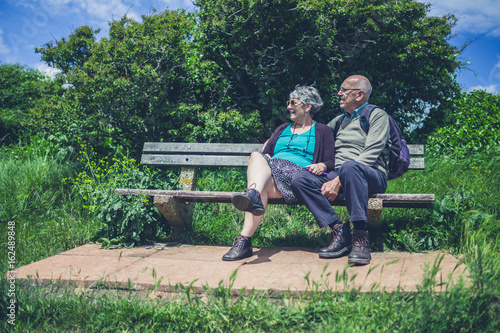 Senior couple relaxing on bench in nature