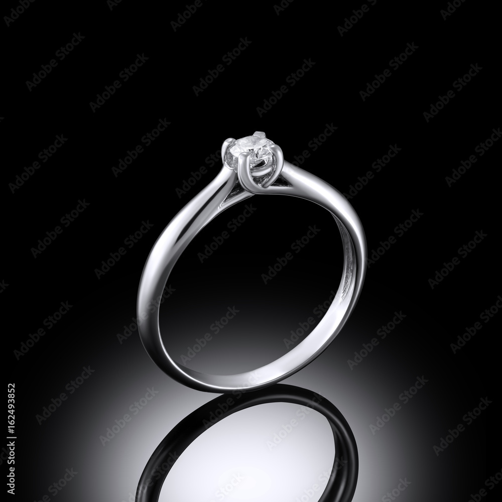 White gold diamond ring on black background with reflection White gold diamond ring on black background with reflection