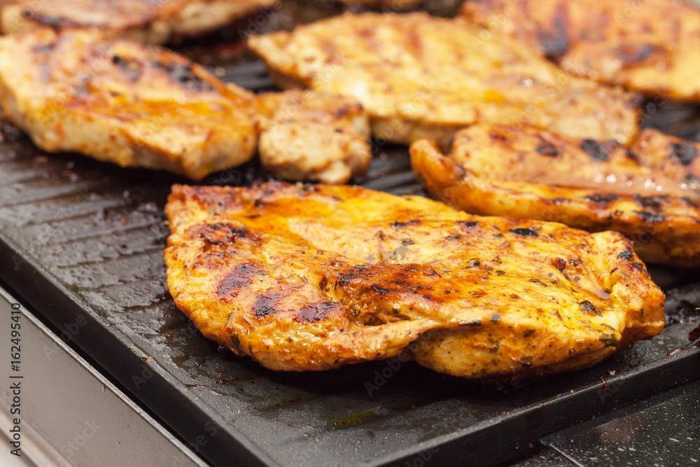 Chicken on electric grill. Summer barbecue. Close-up view. Chicken on electric grill. Summer barbecue. Close-up view.