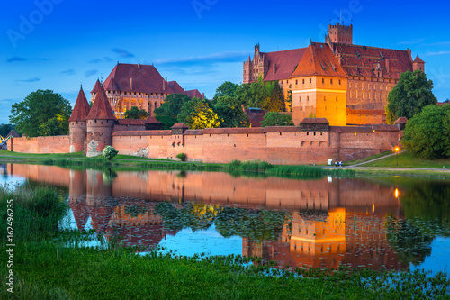 The Castle of the Teutonic Order in Malbork at dusk, Poland photo