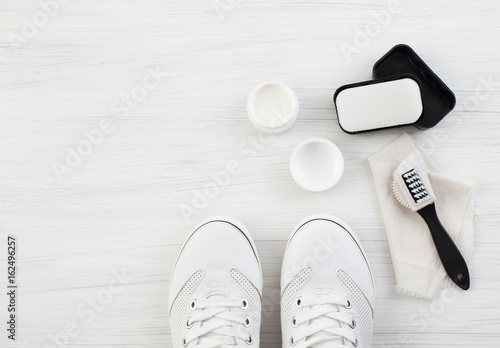 White sneakers and cream with brush and sponge