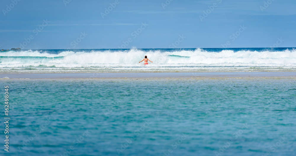 Woman enjoying the sea and waves of Atlantic ocean.