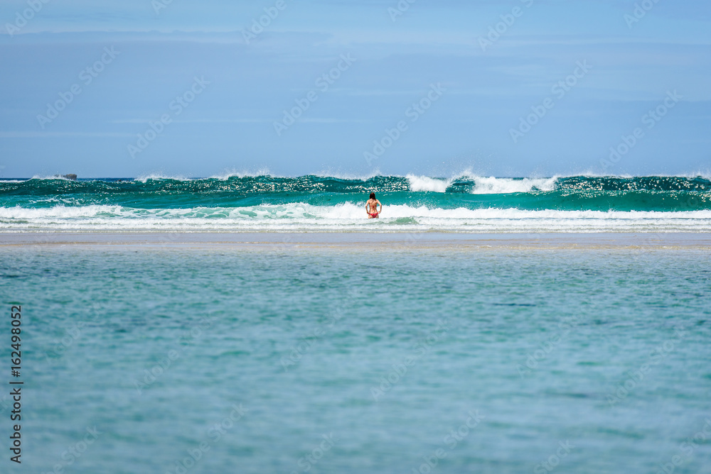 Woman enjoying the sea and waves of Atlantic ocean.