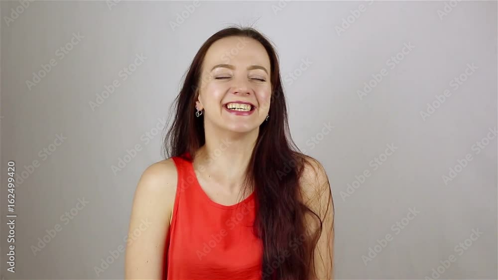 Beautiful young woman laughing and looking at camera Beautiful young woman laughing and looking at camera