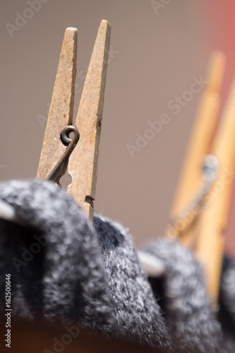 Close up of clothing pegs holding washing on the washline. photo