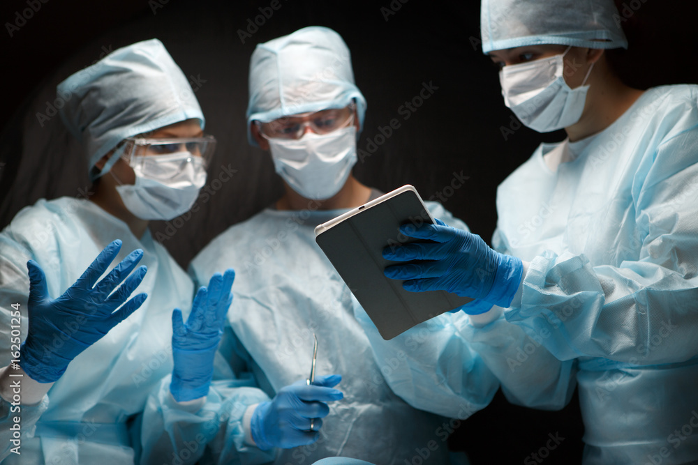 Doctors in operating with tablet Doctors in operating with tablet
