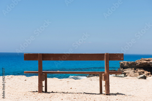 Wooden empty bench with a majestic sea view