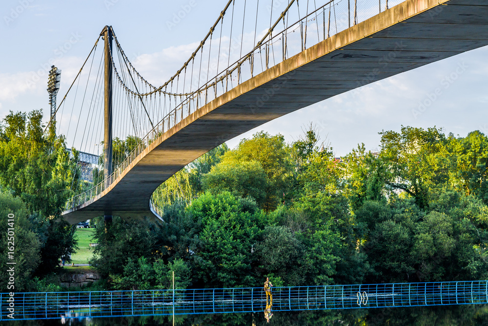 Naklejka premium Suspension bridge over the river