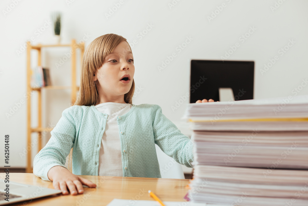Humorous lovely child have a lot of assignments