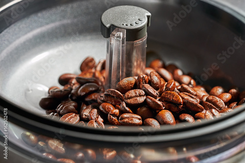 fresh coffee beans in coffee Machine grinders photo