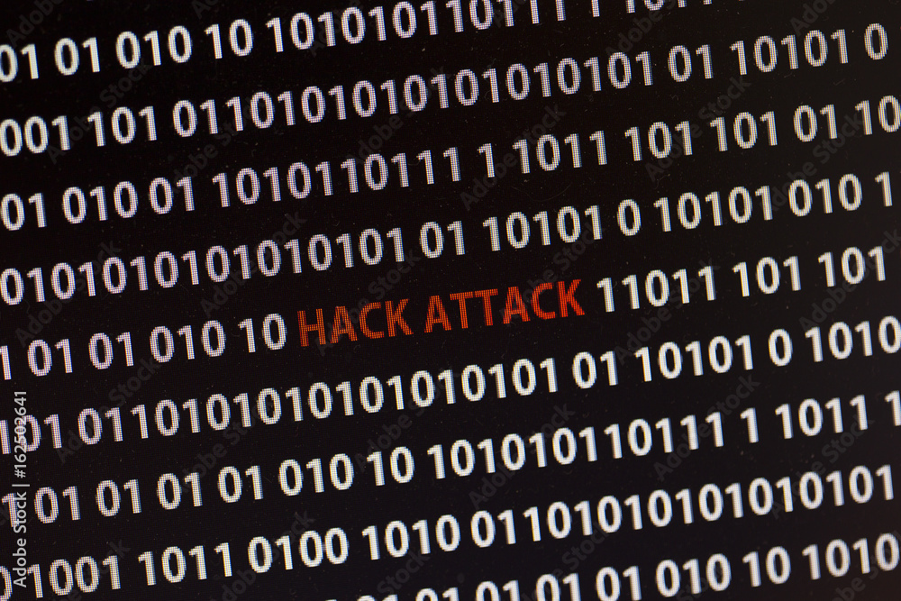 Hack attack text on the computer screen surrounded by numbers one and zero. Hack attack text on the computer screen surrounded by numbers one and zero.