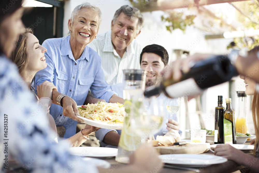 Happy family having lunch together outside Happy family having lunch together outside