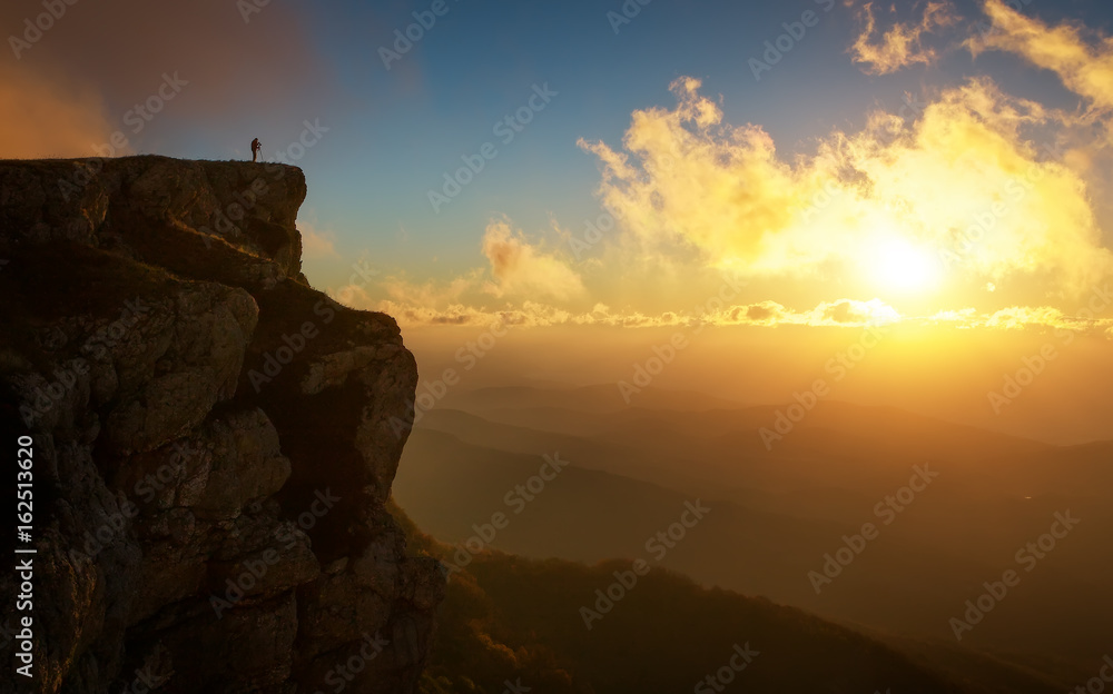 Beautiful mountain landscape with sunset sky in autumn time. Photographer takes pictures on top of the mountain