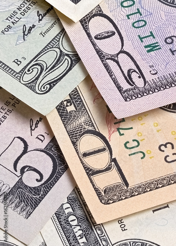 Abstract dollar bills of different denominations background.
