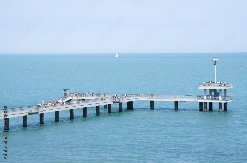 A bridge with a pier and jumping and walking people Burgas, Bulgaria
