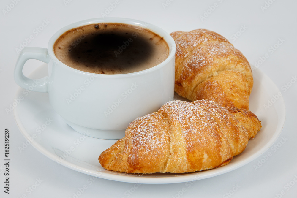 Lush croissants with fragrant coffee for breakfast