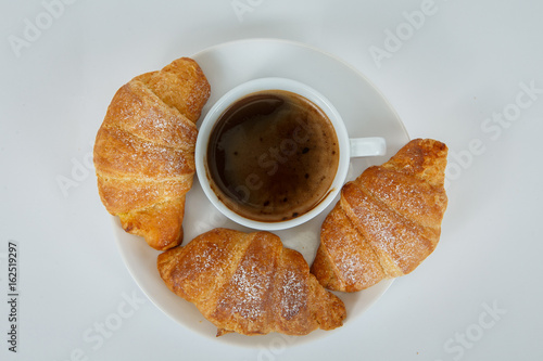 Lush croissants with fragrant coffee for breakfast