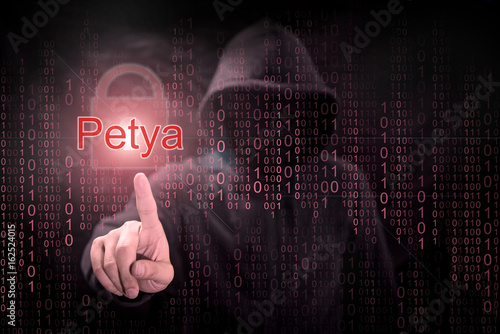 Male hacker pointing Petya or Petrwrap ransomware and red padlock symbol with digital binary code background. cyber attack and internet security concepts photo