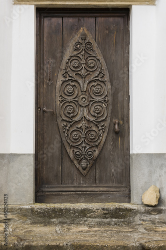 Old carved Door in Montechiaro d'Acqui, Italy photo