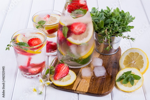 Fruit and herb infused water. Cold refreshing vitamin detox water. Summer drink