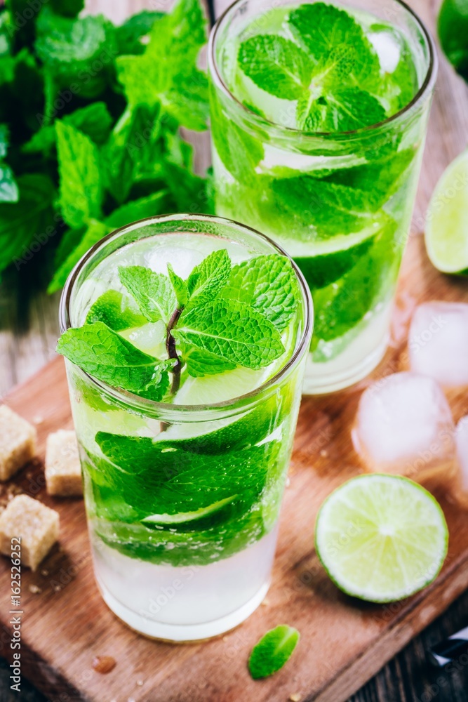 fresh mojito cocktails with lime, mint and ice in glass fresh mojito cocktails with lime, mint and ice in glass