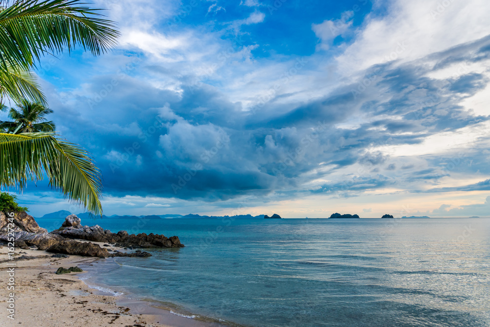 Obraz premium Wild beach with cliffs on a tropical sunset at spectacular sunset background 