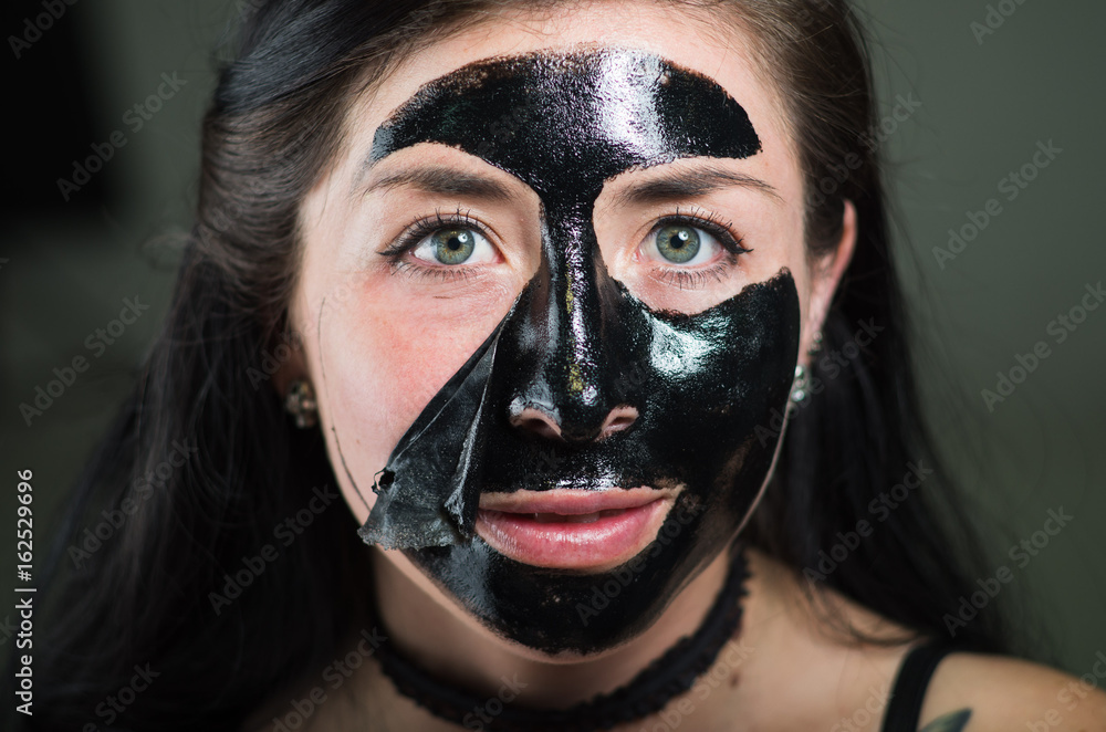Close up of a beauty young woman with a black face mask