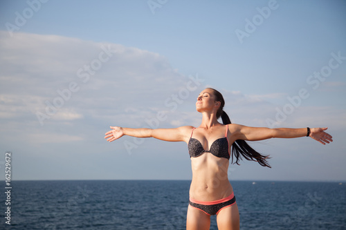 girl in bathing suit sunning on the beach sea