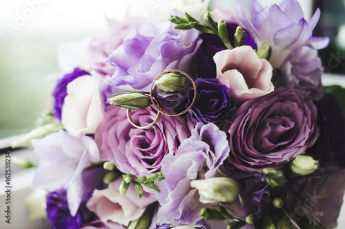Wedding rings on perple flowers