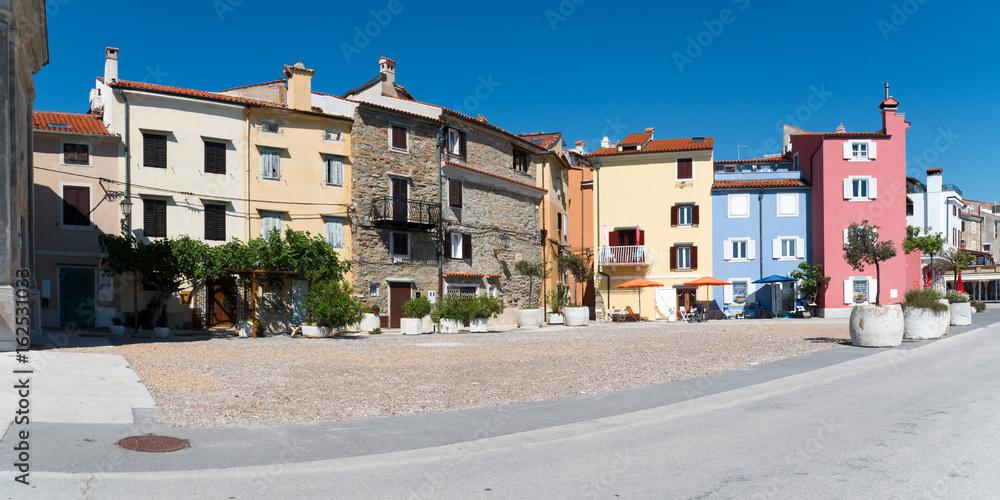 Panoramic view of some old houses on a small square in the picturesque town of Piran in Slovenia