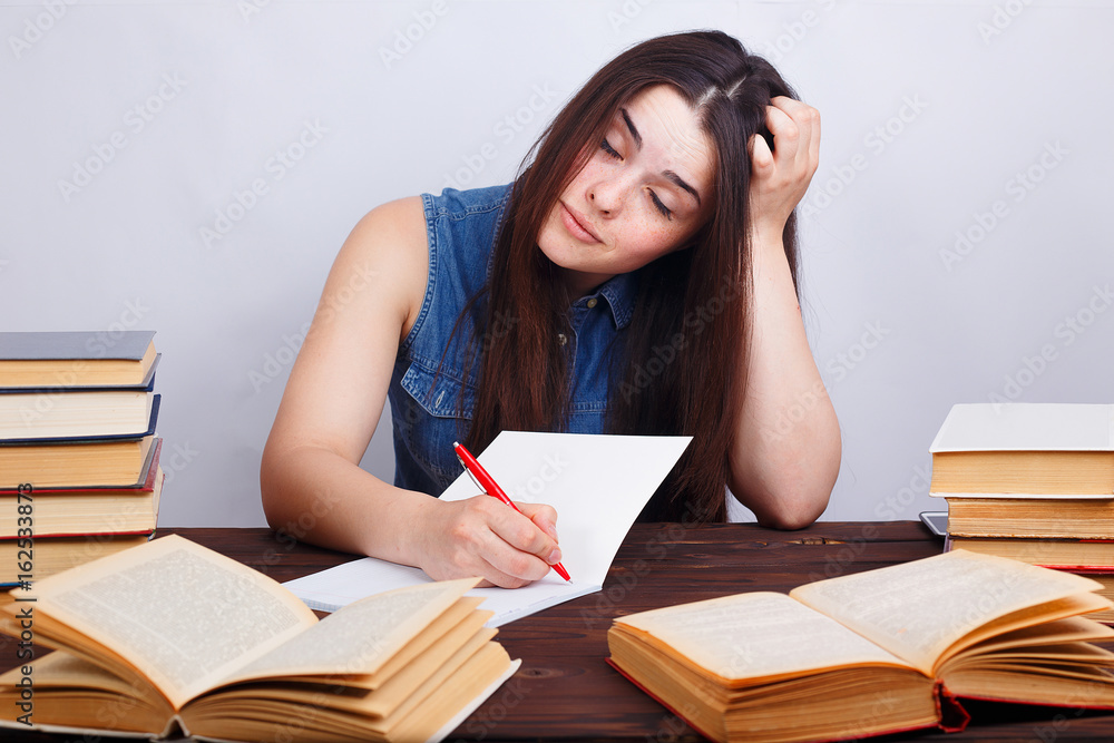 Student girl bored at books Student girl bored at books