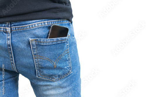 Fototapeta Naklejka Na Ścianę i Meble -  Black smartphone in the right back pocket of jeans isolated on white background with clipping mask.