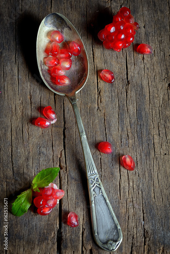 Ripe pomegranate and spoon