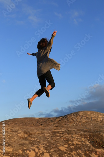 happy women jumping on the sky