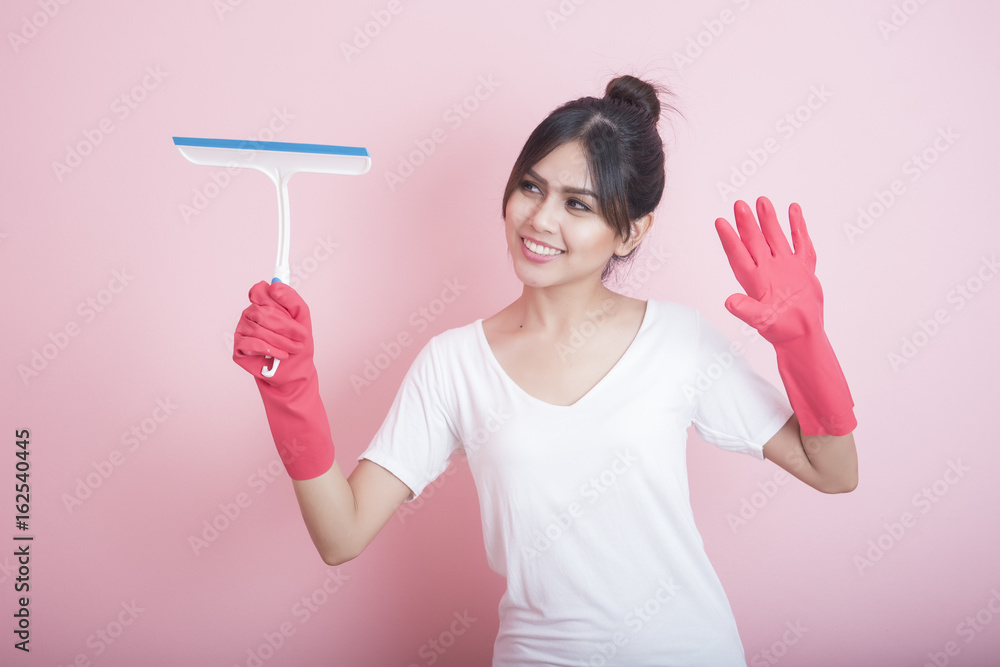 Beautiful asian housewife smiling on pink background Beautiful asian housewife smiling on pink background