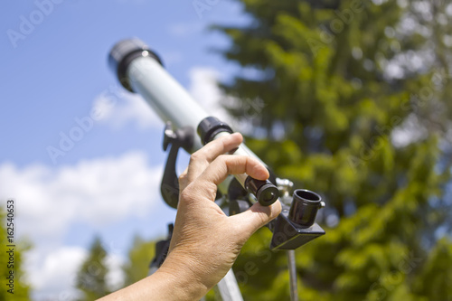 Man Adjusting Telescope