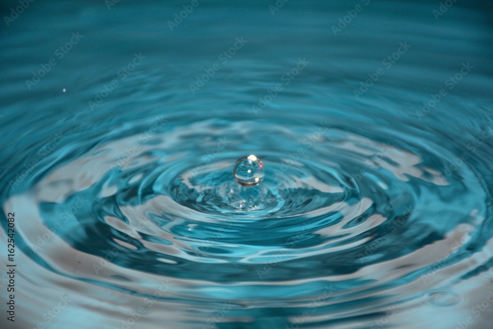 Water drop,falling into water droplets.Abstract blurry background. Water drop,falling into water droplets.Abstract blurry background.