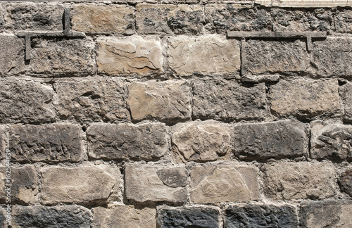 Old sand stone wall closeup as background