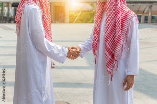 Arab middle eastern Business man handshake at outside office, Success and Happiness Team Concept.