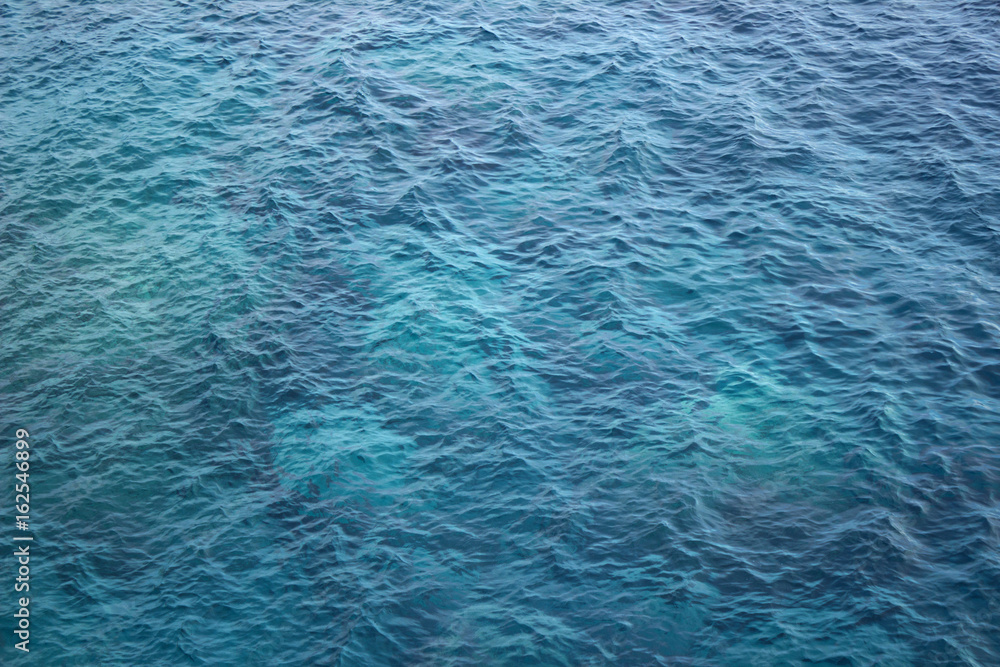Fototapeta premium blue water, a sea under sun rays background