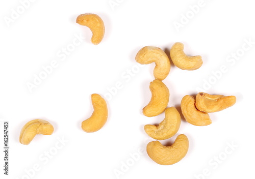 Unshelled roasted and salted cashew nuts isolated on white background, top view 