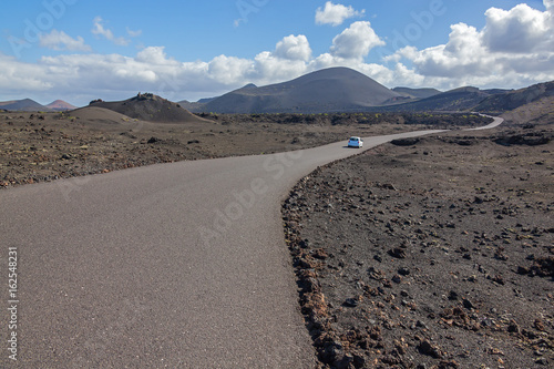 Picturesque road through volcanic terrain in the Timanfaya national park on Lanzarote island  Canary Islands  Spain