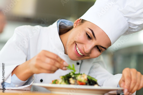 Female chef in kitchen
 photo