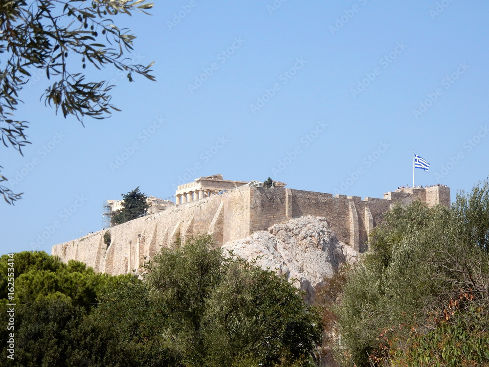 Acropolis in a sunny day with a flying flag