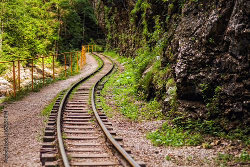 railway in the gorge with yellow railing along the cliff