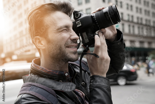Tourist in New york city taking pictures with photo camera