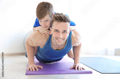 Dad and son doing push-ups ...
