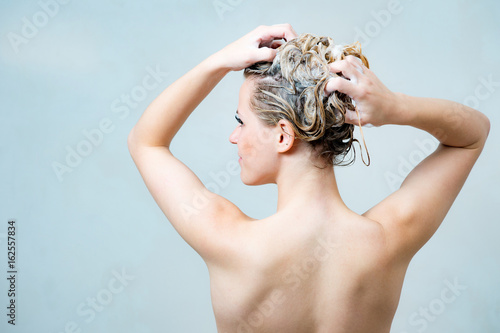 young woman under shower in bath room
