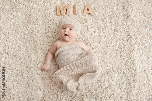 Cute baby with word MIA lyi...